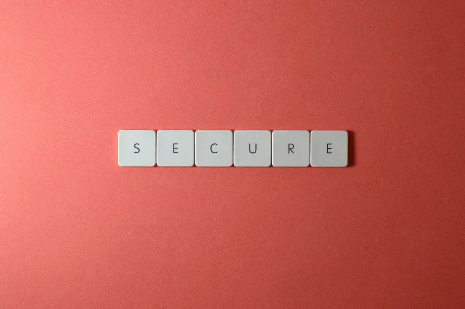 The word SECURE spelled out in white letter keys on a red background